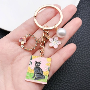 Pink sakura and tarot cat charm keychain with gold ring and synthetic pearl pendant