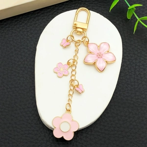 Pink cherry blossom and butterfly enamel keychain with gold metal D-ring clasp for bags