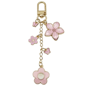 Golden keychain with pink enamel cherry blossoms and butterflies on a lobster clasp