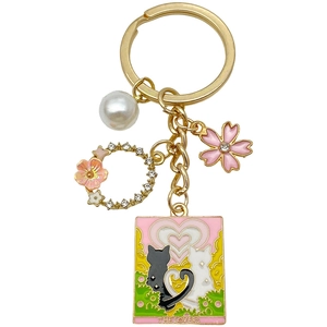Pink heart cat enamel keychain with cherry blossom, pearl, and rhinestone wreath detail