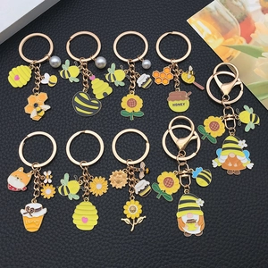 Süßes Schlüsselanhänger-Set mit Bienen- und Sonnenblumen-Motiven aus goldenem Metall