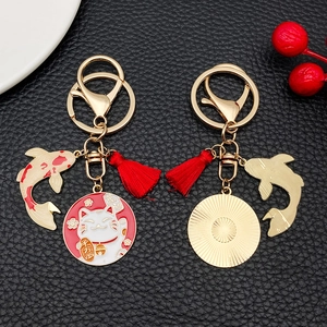 Creative Maneki Neko lucky cat keychain with red tassel and koi fish charm in gold finish