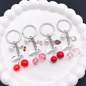 Creative resin cherry fruit keychain set with imitation pearl charms in four vibrant colors