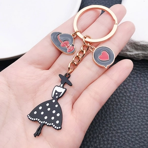 Elegant gold keychain featuring black dress lady and hat charms for women bags