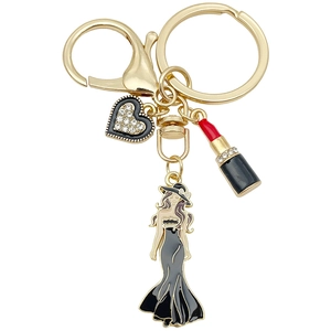 Goldener Schlüsselanhänger mit schwarzem Emaille-Herz, Lippenstift und Damen-Figur