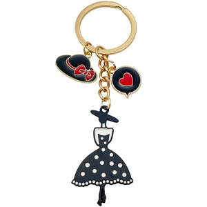 Elegant gold keychain featuring black enamel dress, hat and heart pendants for women