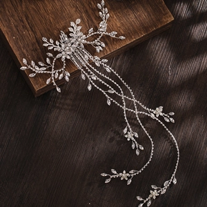 Dettaglio di un pettine per capelli da sposa con nappe di strass su legno scuro