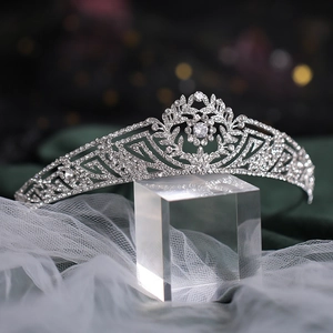 Detailed view of silver bridal crown with intricate rhinestones on velvet background