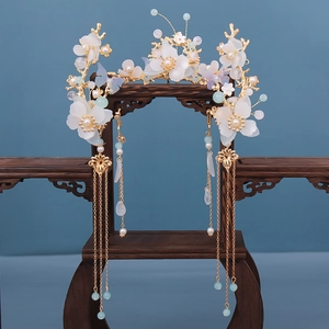 Detailed macro of golden Hanfu crown featuring resin flowers and long tassel pendants