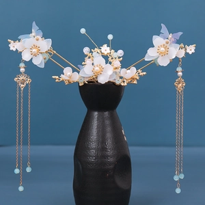 Detailed close-up of retro Chinese hair crown set with blue silk flowers and golden tassels