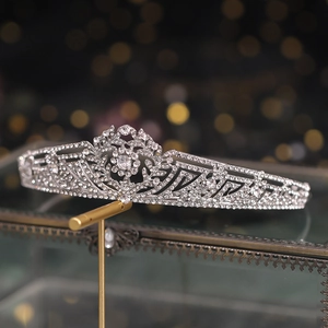 Elegant bridal tiara with silver rhinestones on a display stand for wedding accessories