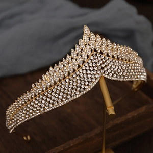 Macro detail of gold crown with sparkling white rhinestones in a wave pattern