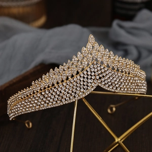 Detailed macro view of vintage golden bridal crown featuring intricate leaf textures and rhinestones