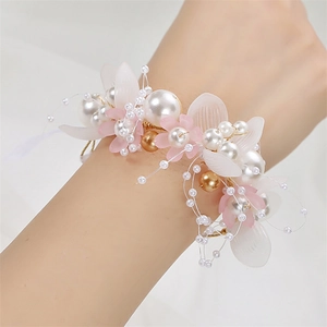 Elegant bridal wrist corsage with pink resin flowers, white pearls and gold wire details