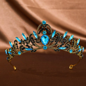 Detail of vintage gold crown with blue teardrop crystals and black rhinestones