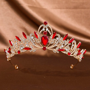 Detailed close-up of a gold wedding crown featuring teardrop red gemstones and rhinestones
