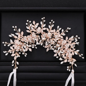 Macro detail of rose gold bridal hair vine with rhinestone flowers and metallic leaves
