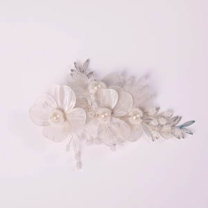 Detailed macro view of handmade silver flower headband with translucent petals and pearls