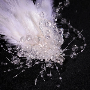 Romantic white feather hair clip with crystal beads for elegant bridal hair styling