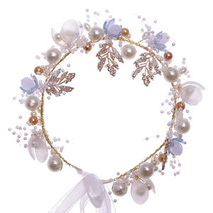 Floral bridal headband with pearls, gold leaves, and sheer ribbons for wedding hair styling