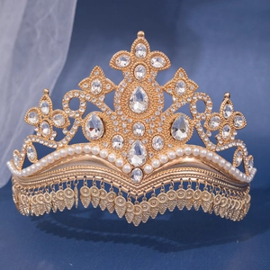 Detailed view of luxury gold bridal crown with white rhinestones and fringe tassels