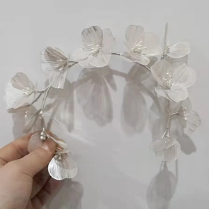 Detail view of handmade white lace flower bridal headband with pearls and silver wire