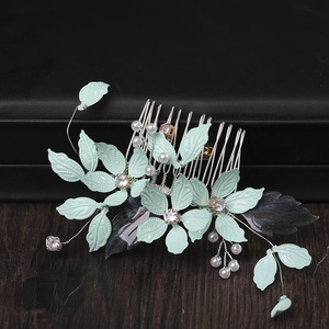 Mint green leaf bridal hair comb with floral accents and pearls for elegant wedding hairstyles