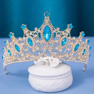 Detailed close-up of a bridal tiara with blue teardrop stones and sparkling white zircons