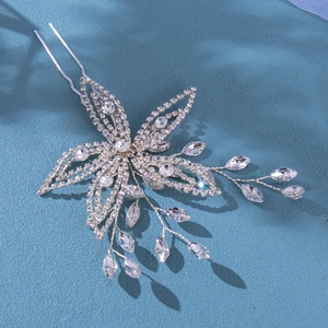 Exquisite bridal U-shaped hair pin featuring rhinestone floral design on a blue background
