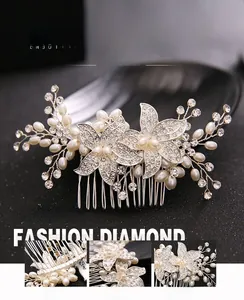 Detail of silver bridal hair comb featuring alloy flowers with rhinestones and faux pearls