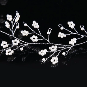 Handmade bridal hair vine with white pearls and silver wire on elegant black background