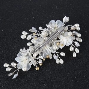 Elegant bridal hair clip with white silk yarn flower and pearls on silver metal base