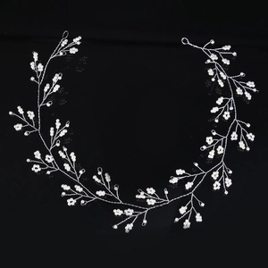Elegant bridal hairband with white pearls and silver wire in a delicate branch design