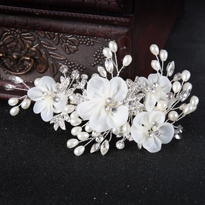 Elegant white fabric flower bridal headpiece with pearls and rhinestones on wood box