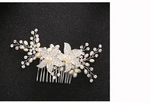 Close-up detail of handcrafted bridal hair comb with rhinestones and white pearls