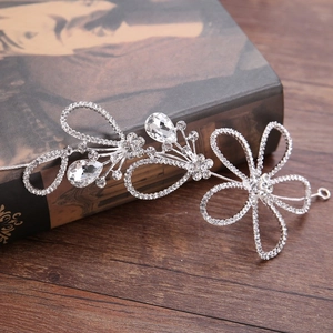 Detailed view of silver bridal headband with hollow flower design and pear-shaped rhinestones