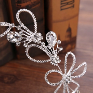 Detailed close-up of bridal headband featuring silver floral clusters and sparkling rhinestones