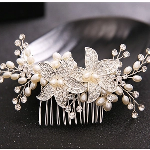 Elegant silver bridal hair comb with crystal flowers and white pearls for wedding styling