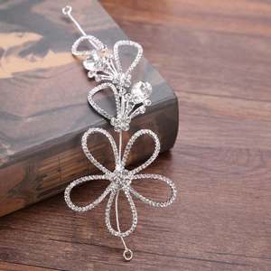Silver bridal headband with rhinestone hollow flowers on a vintage book background