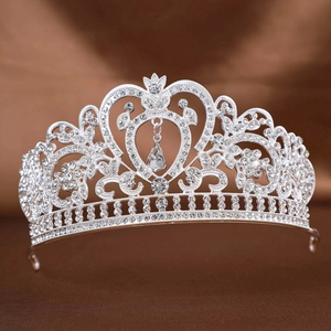 Baroque silver bridal crown with teardrop crystal and sparkling rhinestones on brown satin