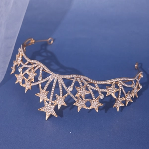 Detail of a gold star bridal crown with sparkling rhinestones on dark blue background