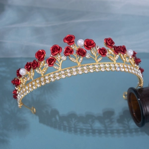 Detailed close-up of bridal gold crown with handmade red roses, pearls and crystals