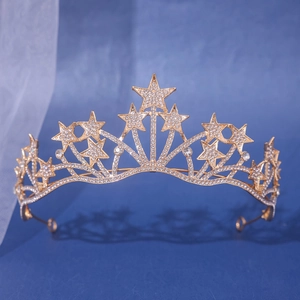 Golden bridal star crown with sparkling rhinestones on a dreamy blue textured background