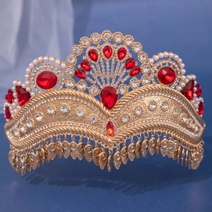 Detail of luxury bridal crown with red rhinestones, white pearls and golden tassels
