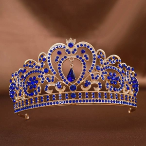 Golden Baroque bridal crown with intricate filigree and blue teardrop crystal accents