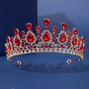 Macro view of a gold tiara with vibrant red pear-shaped crystals and fine diamonds