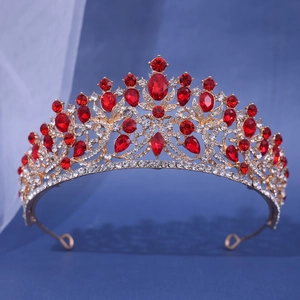 Detail of vintage gold bridal crown with ornate red crystals and teardrop rhinestones
