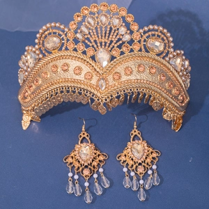 Detailed close-up of luxury bridal crown and earrings with champagne crystals and pearls