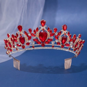 Macro detail of red crystal bridal crown with golden base and integrated hair combs