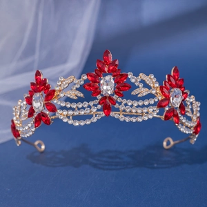 Close-up of elegant gold bridal crown with red marquise crystals and clear rhinestones
